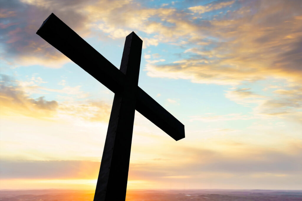 Depositphotos_281442216_XL Cross in silhouette with a colorful sky and cloud — Photo by f11photo