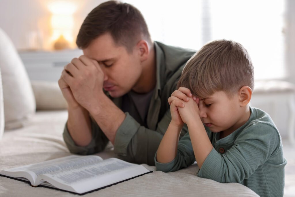Depositphotos_867019564_XL Sitting in silent prayer. Shot of a young man praying in a church.